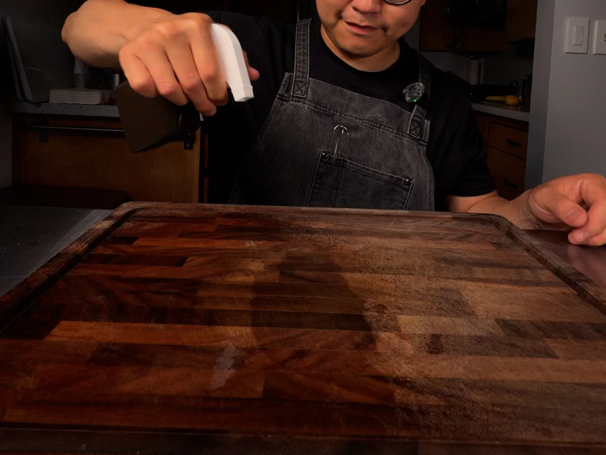 Applying liquid to a wooden board from a bottle