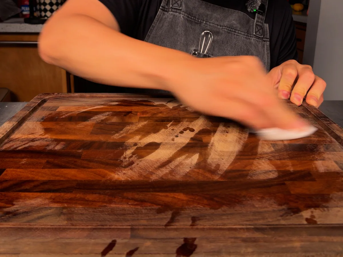 Rubbing down a wooden board by hand