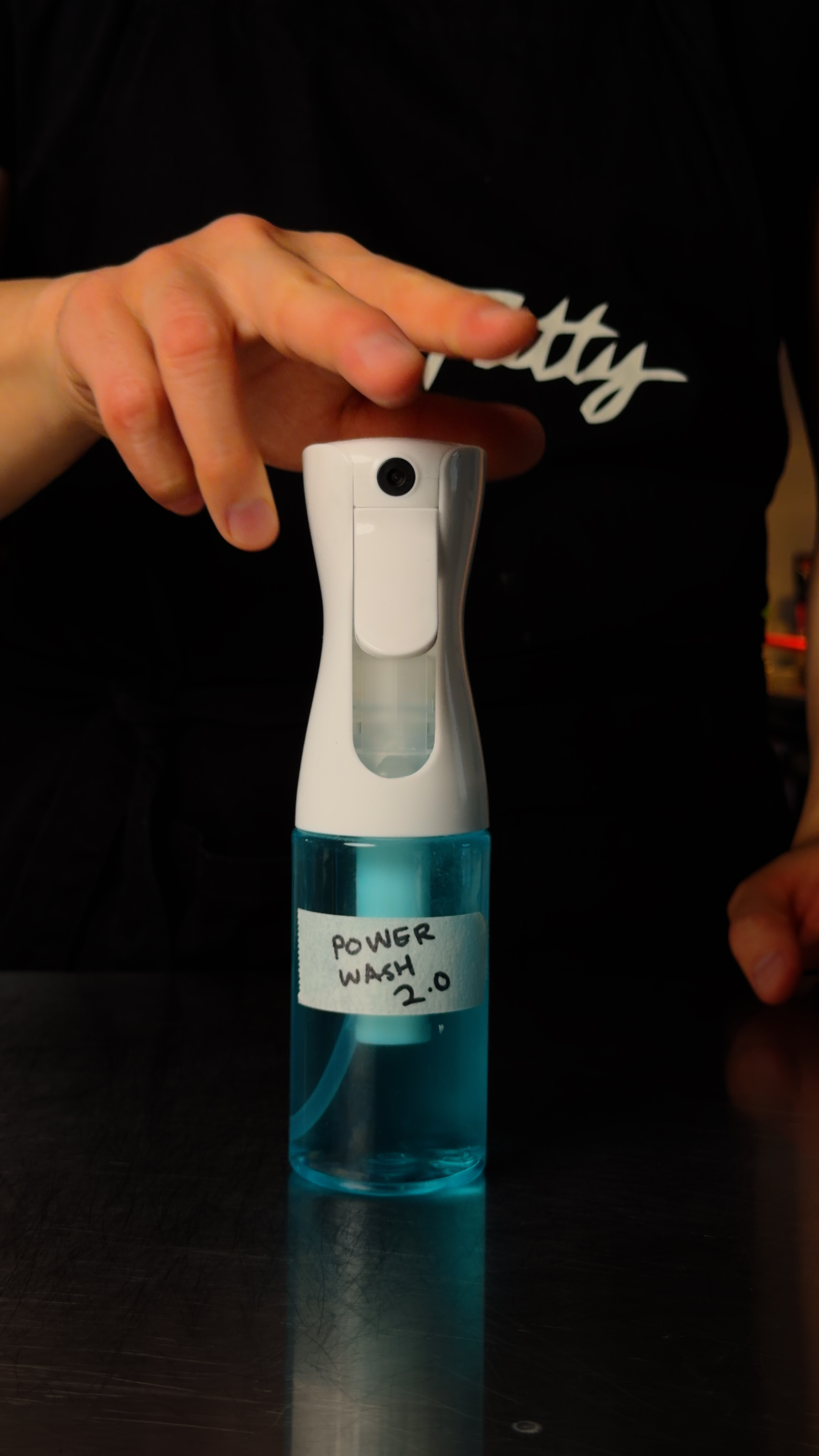 A refillable foaming spray bottle labeled Power Wash 2.0 filled with blue homemade dish spray