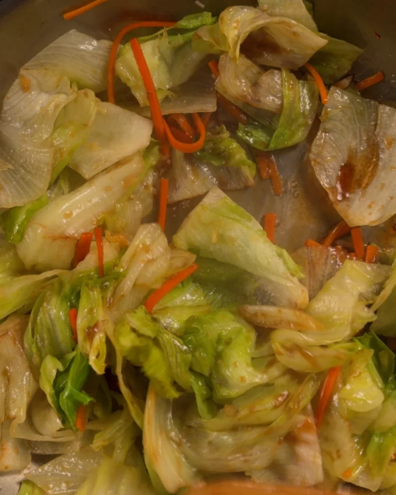 Garlic oyster-sauce stir-fried iceberg lettuce with carrot in a pan