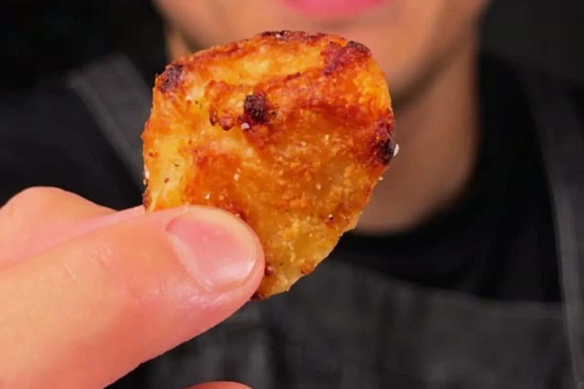 Deep golden, shatter-crisp roast potatoes on a sheet pan