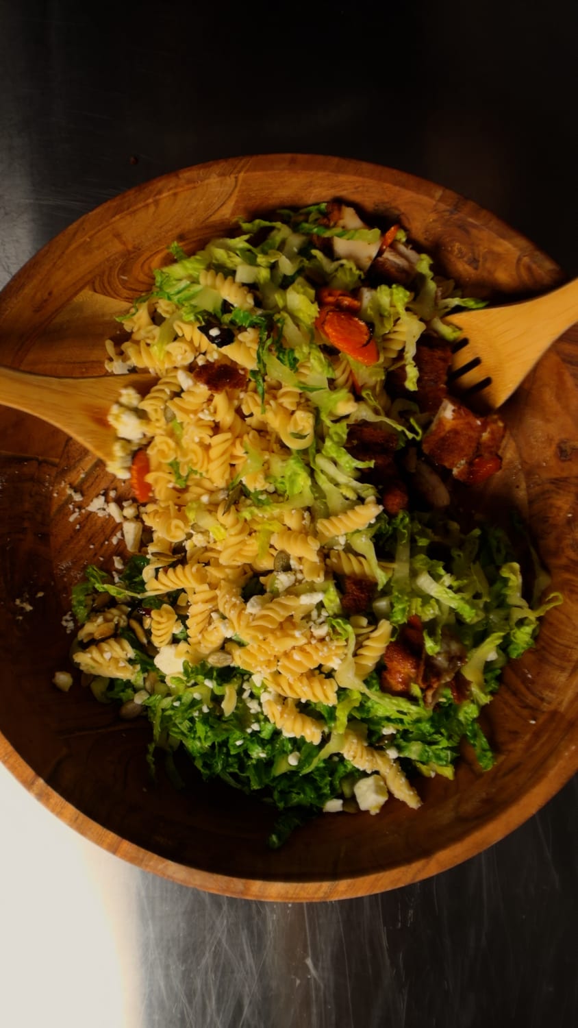 The Honey Crunch Chicken Salad fully tossed in a wooden bowl with serving spoons