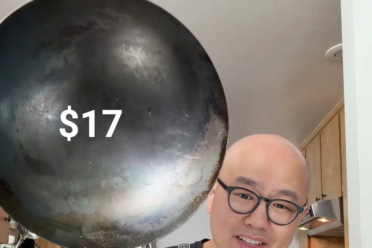 Chef Fatty holding up a $17 carbon steel wok