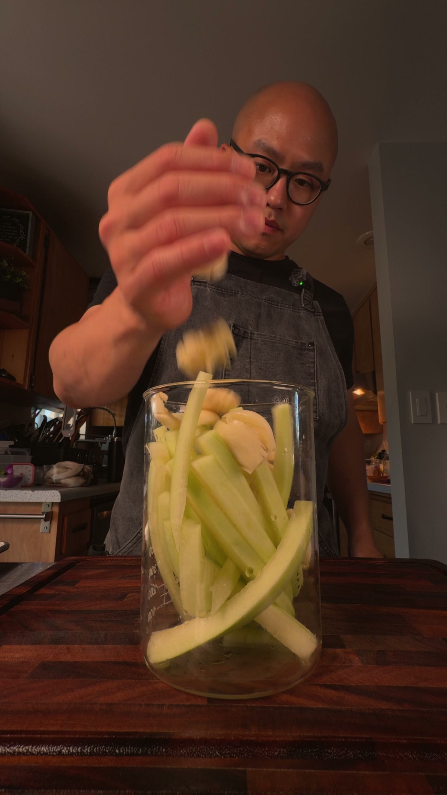 Packing the jar with garlic and peppercorns.