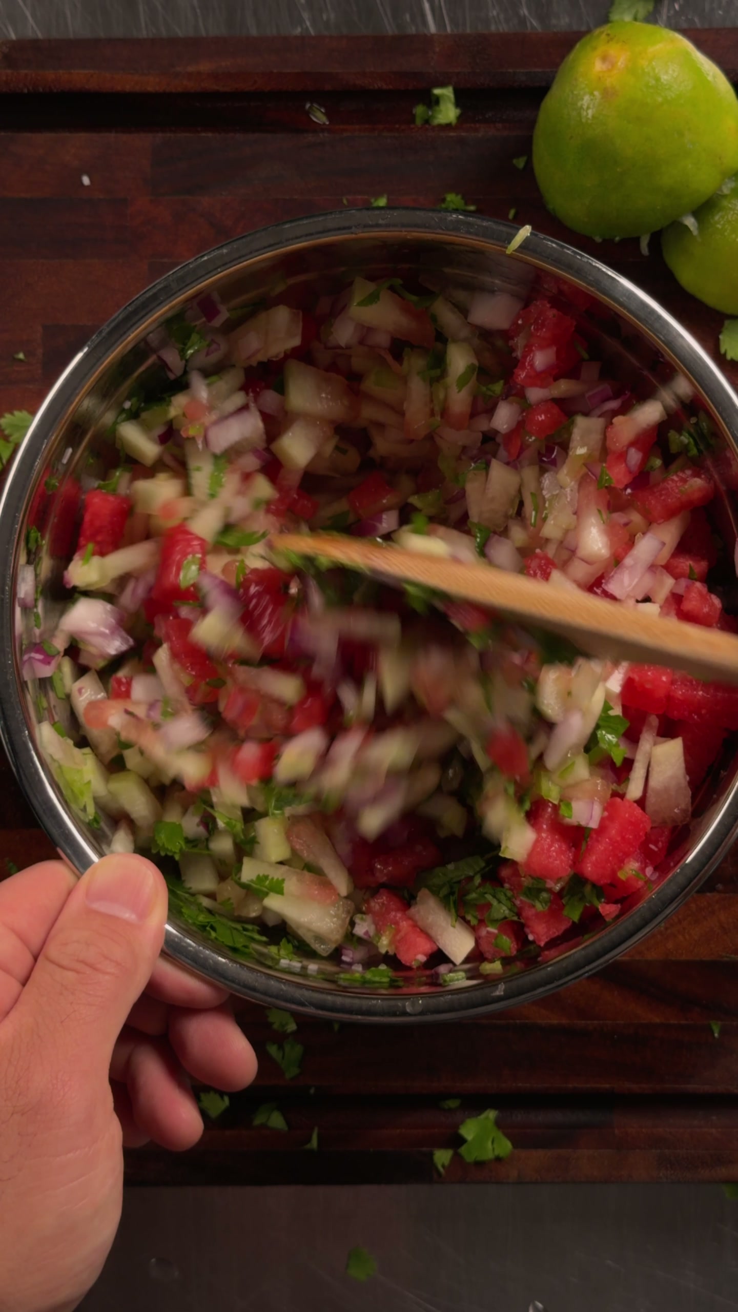 Tossing the finished pico de gallo.