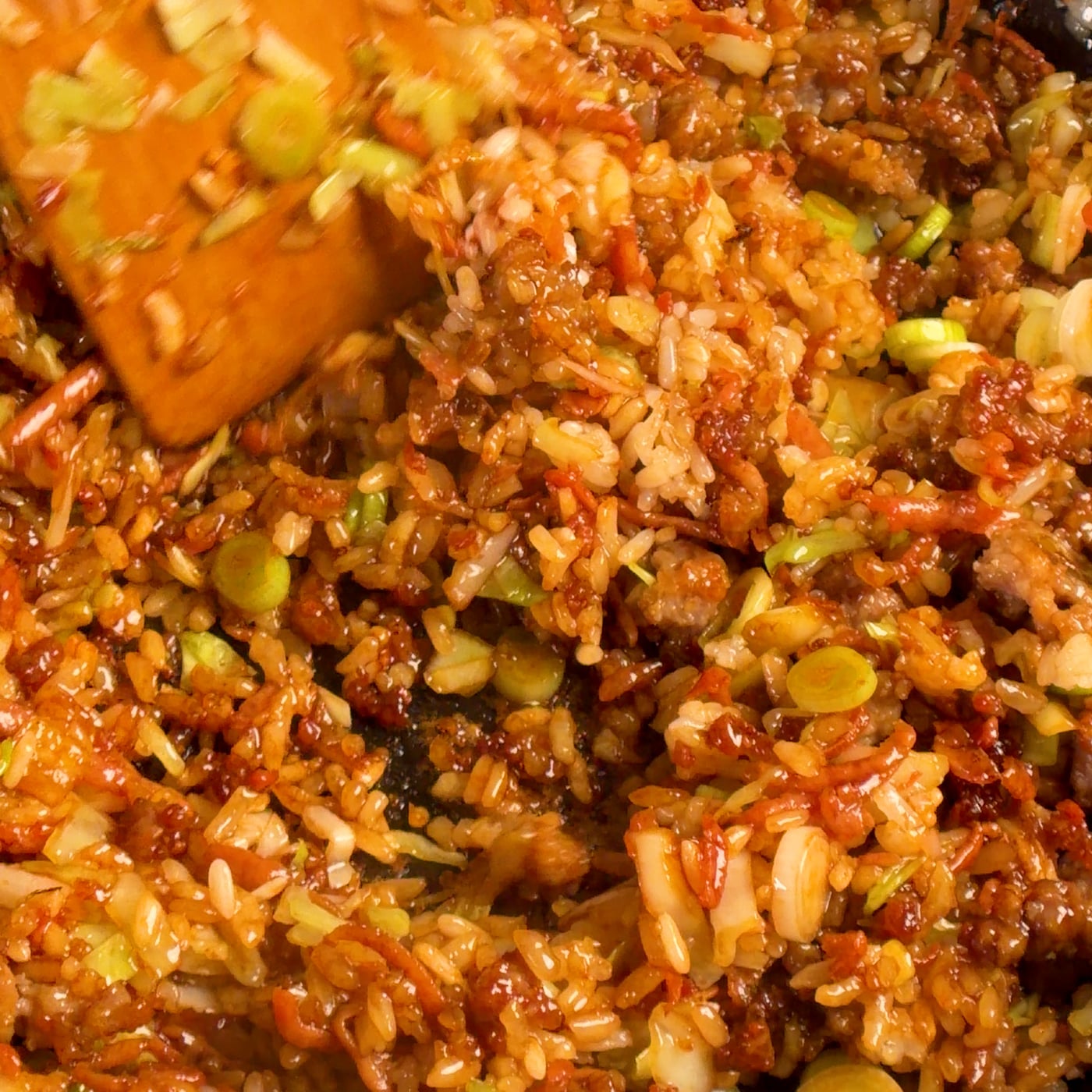 Finished crispy pork fried rice in a thin enameled cast iron pan, ready to be plated
