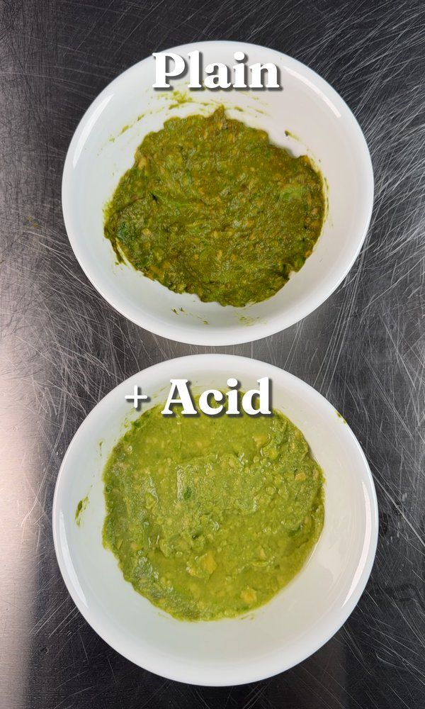 Overhead view of two bowls of guacamole labeled Plain and +Acid, showing clear color difference