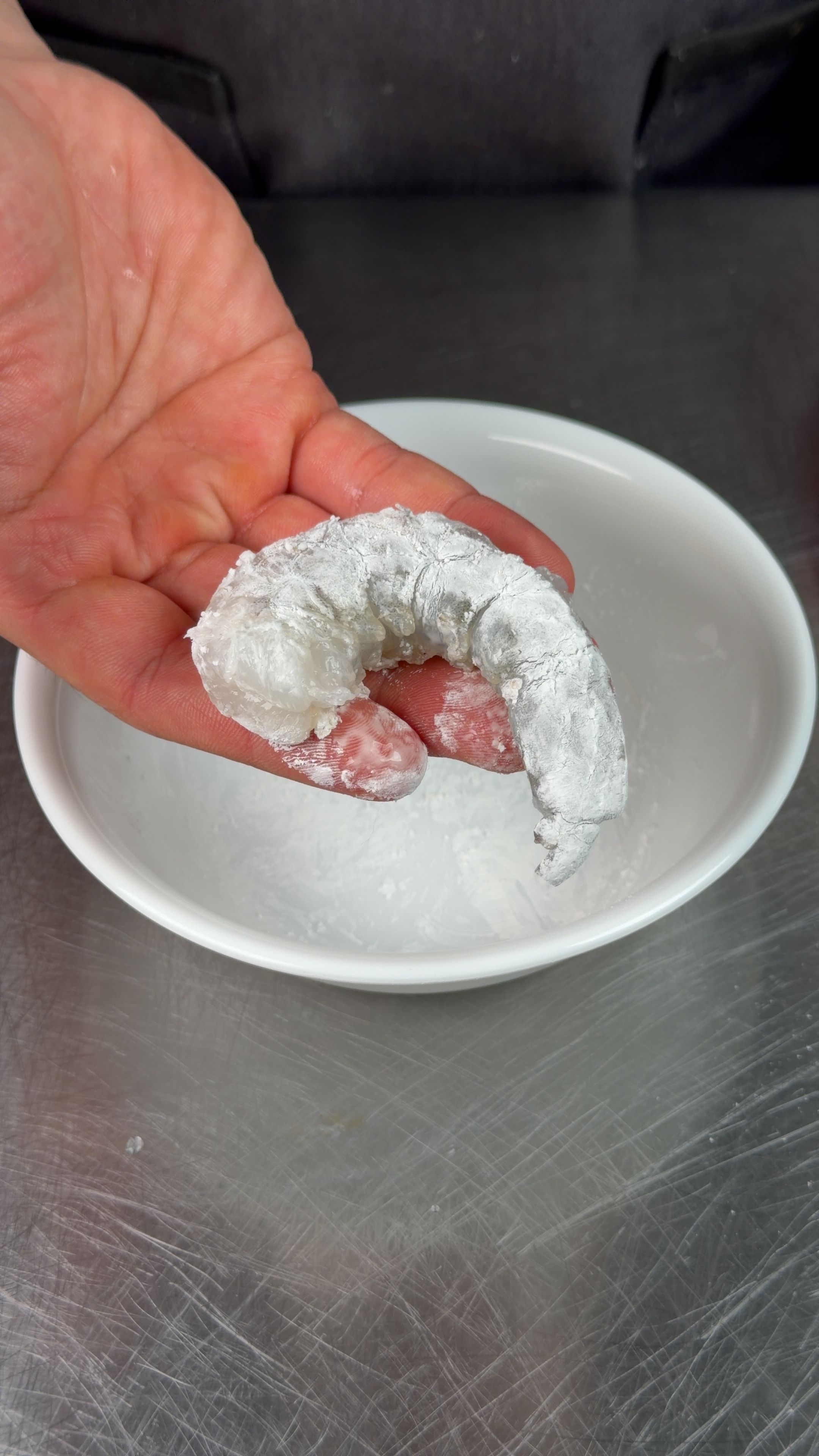 Shrimp fully coated in cornstarch, showing the thick white layer