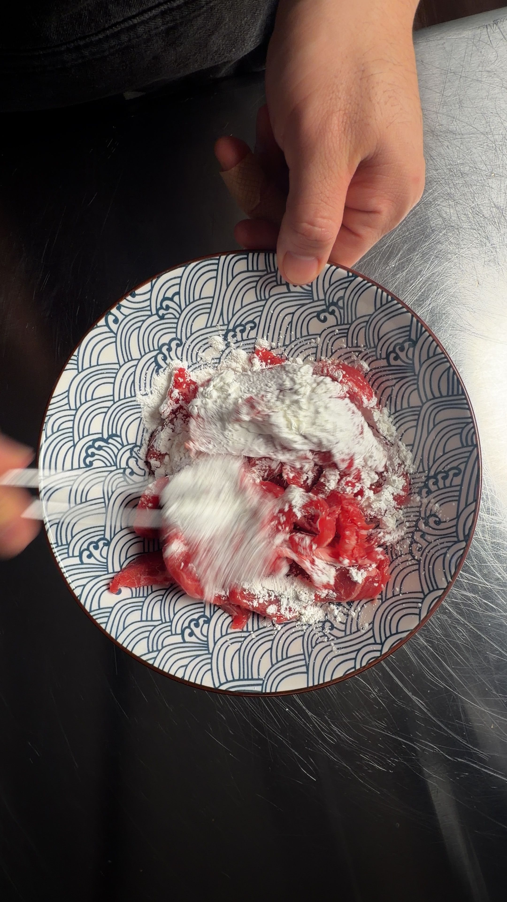 Shrimp being tossed with cornstarch in a Japanese bowl