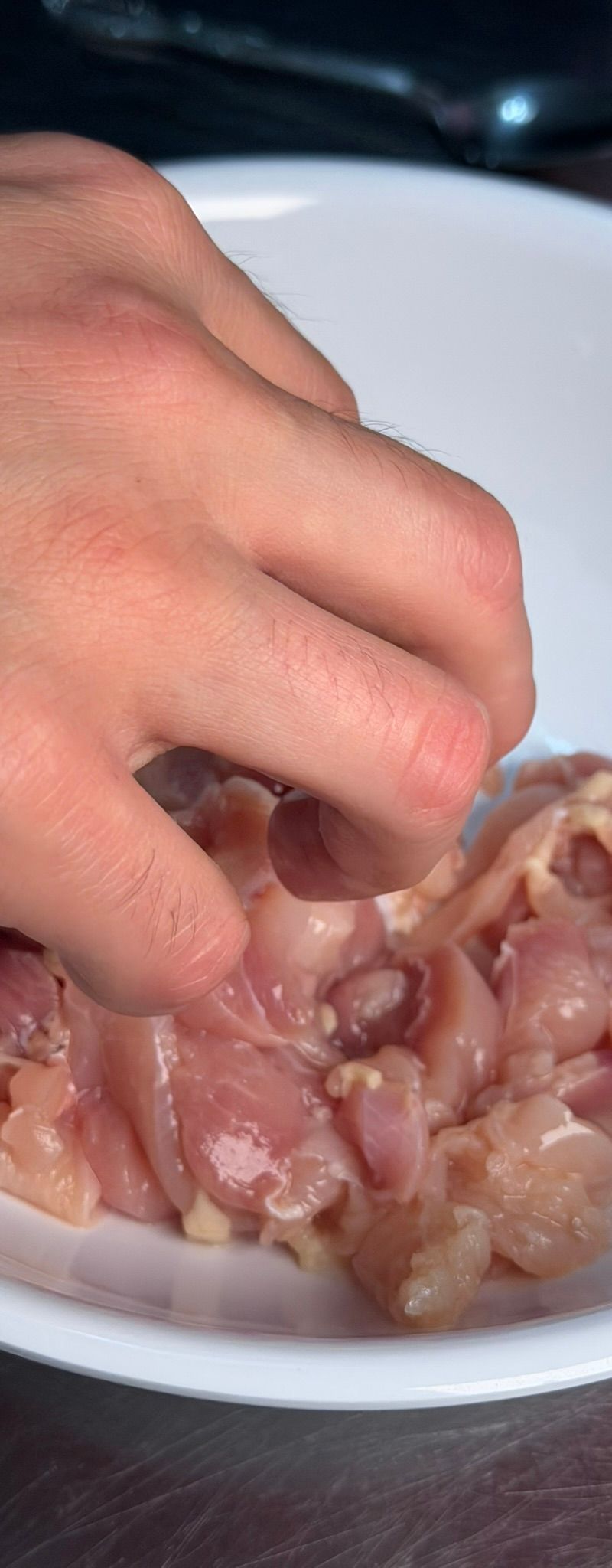 Massaging the baking soda and oil into the chicken