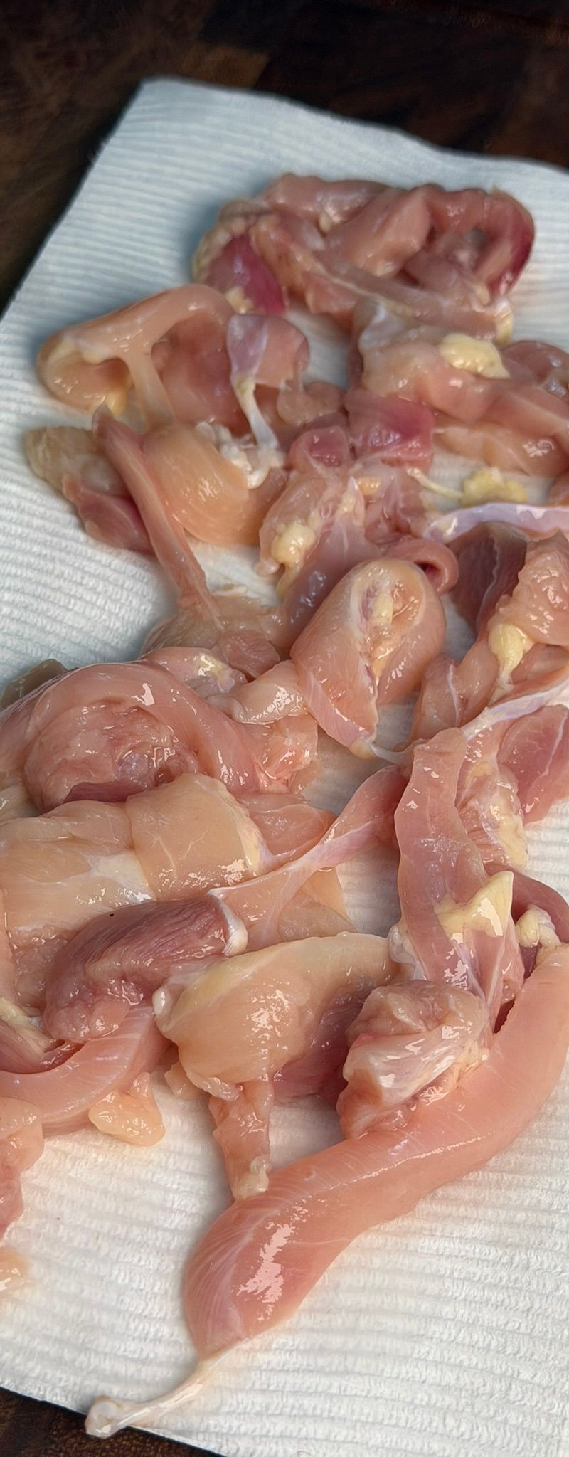 Patting chicken dry with paper towels