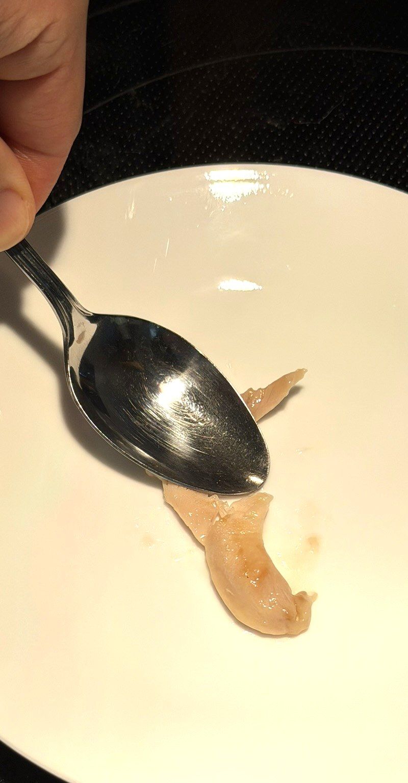 Finished velveted chicken, so tender you can break it apart with the back of a spoon